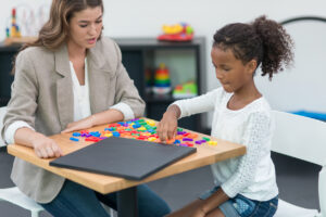 Happy kids doing fun exercises with occupational therapist.